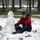 A man poses for a picture next to a snowman outside a forested area in the Sidi al-Hamri region of Libya’s eastern Jebel Akhdar (Green Mountain) upland region, about 200 kilometres east of Benghazi, on February 16, 2021.